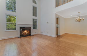 A gas fireplace with a classic mantel adds warmth and visual appeal to the great room. Oversized windows fill the open, airy floorplan with natural light.