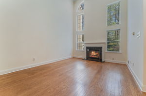 A gas fireplace with a classic mantel adds warmth and visual appeal to the great room. Oversized windows fill the open, airy floorplan with natural light.