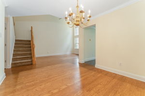 Hardwood flooring flows from the foyer into the dramatic two-story great room and formal dining room, highlighted by crown moulding.