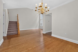 Hardwood flooring flows from the foyer into the dramatic two-story great room and formal dining room, highlighted by crown moulding.   Stairway with NEW CARPETING!