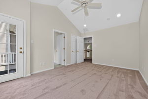 The primary bedroom features a cathedral ceiling, recessed lighting, ceiling fan, walk-in closet, and NEW CARPETING, with direct access to a private deck.