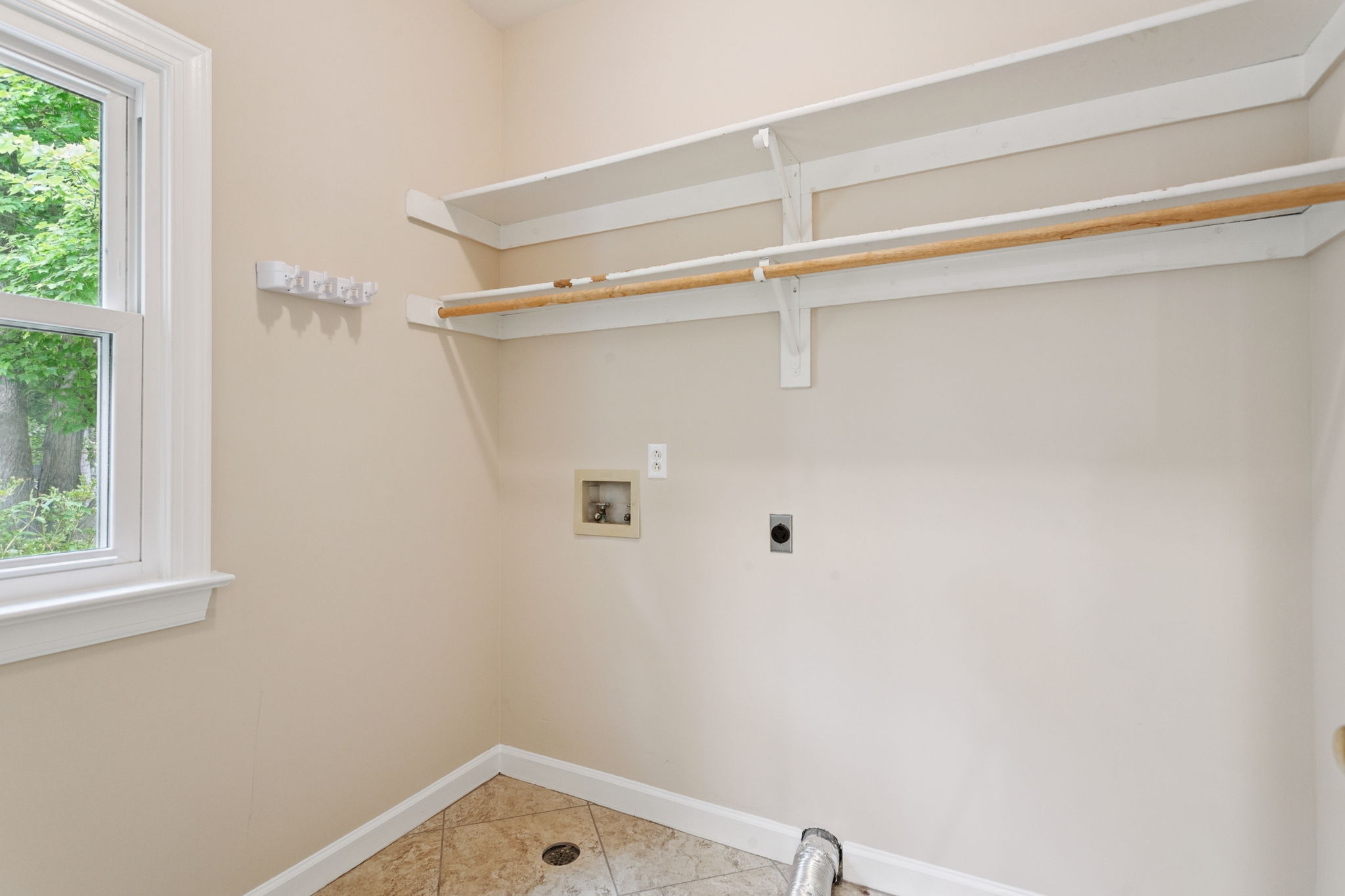 Functional laundry room with easy access to garage.