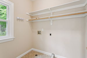 Functional laundry room with easy access to garage.