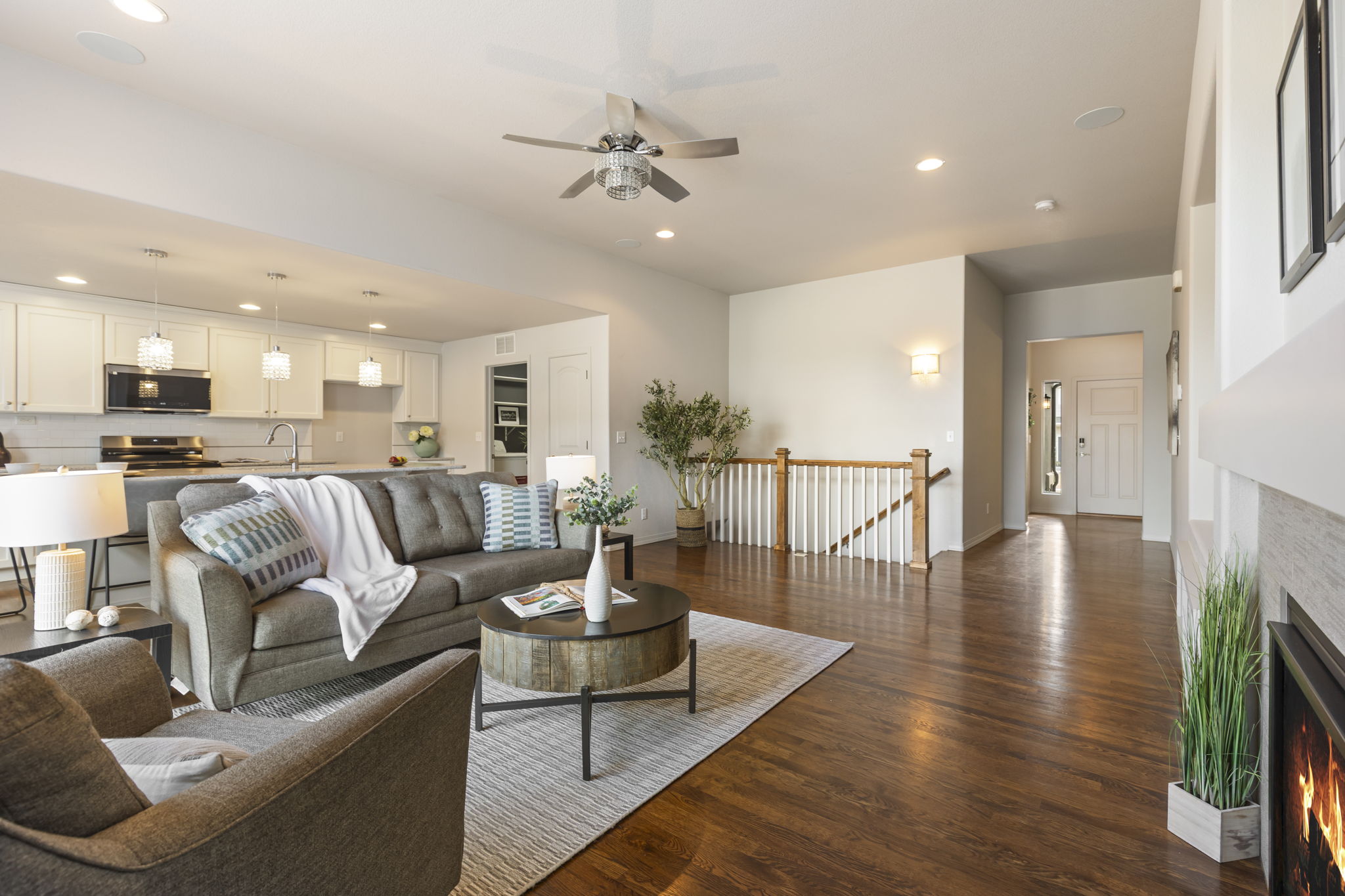 Open-concept main-level living with hardwood floors and seamless flow to the kitchen and dining areas.