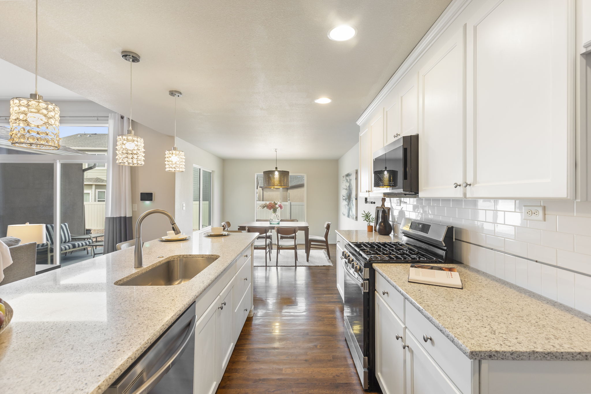 Kitchen view highlighting gas range, stone countertops, and extended counter space for food prep and entertaining.