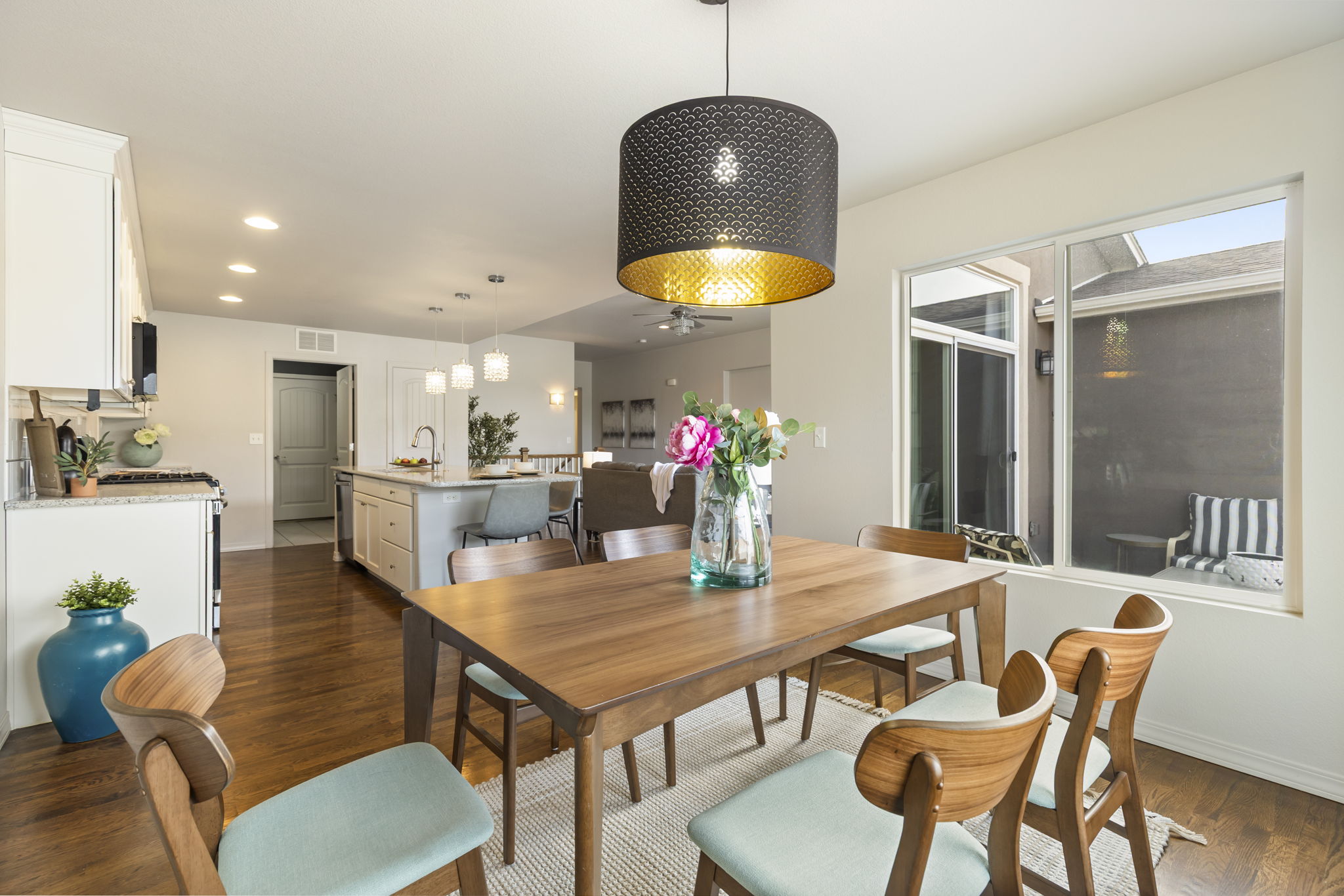 Dining space connected to the kitchen, showcasing hardwood floors and open sightlines.