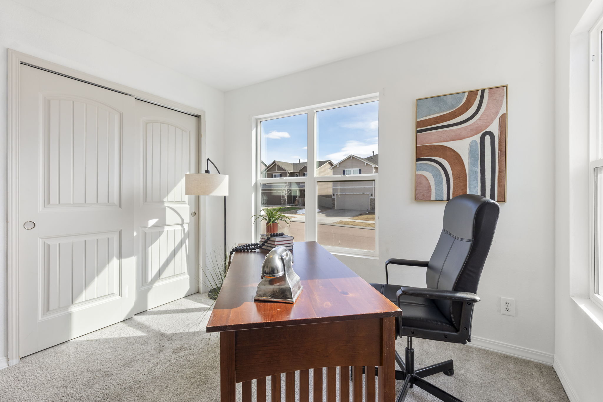 Alternate view of main-level bedroom or office space, ideal for guests or remote work.