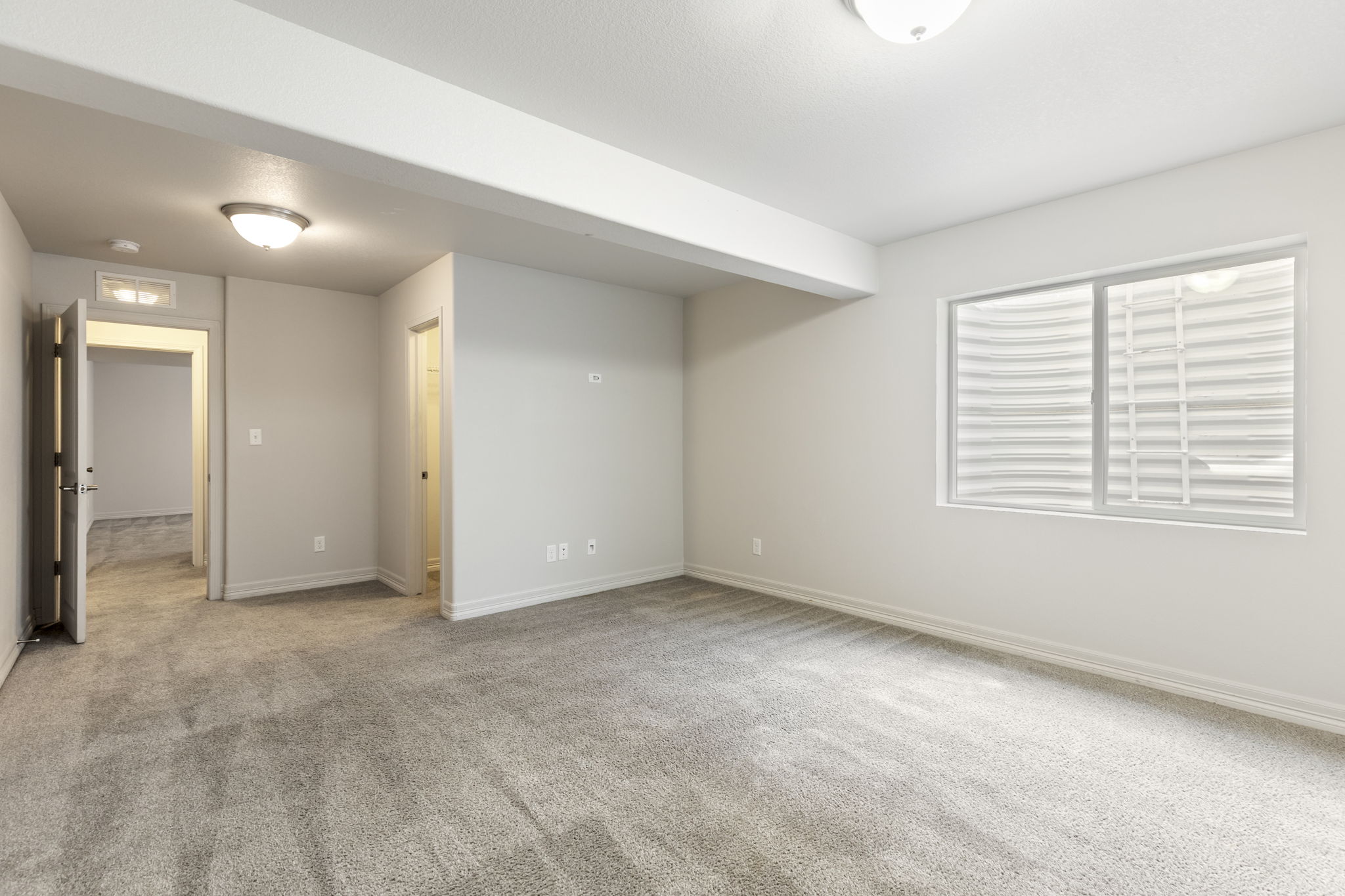 Alternate view Large finished basement bedroom 2 area with multiple rooms offering flexibility for guests, office, or recreation use.