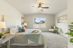 Alternate view of the primary suite with view of backyard