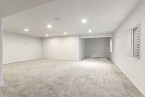 Spacious finished basement recreation room with recessed lighting and flexible open layout.
