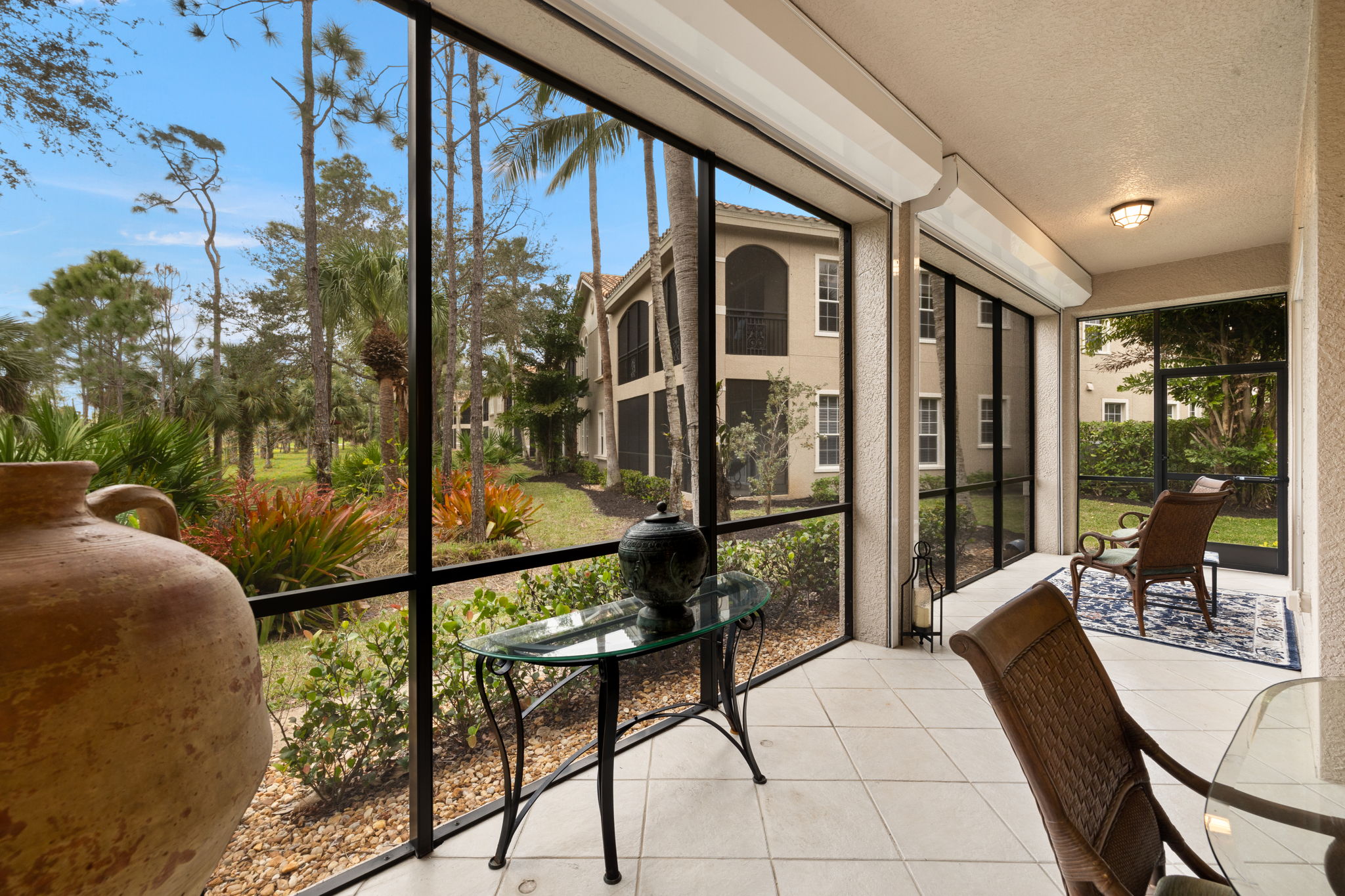 Lanai tiled in  same neutral tone  as the house