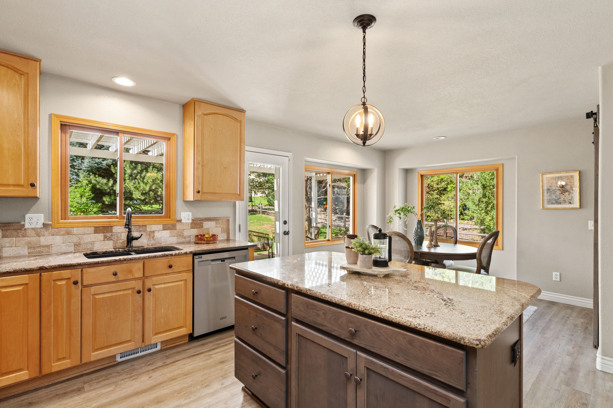Eat-in kitchen with granite countertops, walk-in pantry, located off the main floor laundry room and garage.
