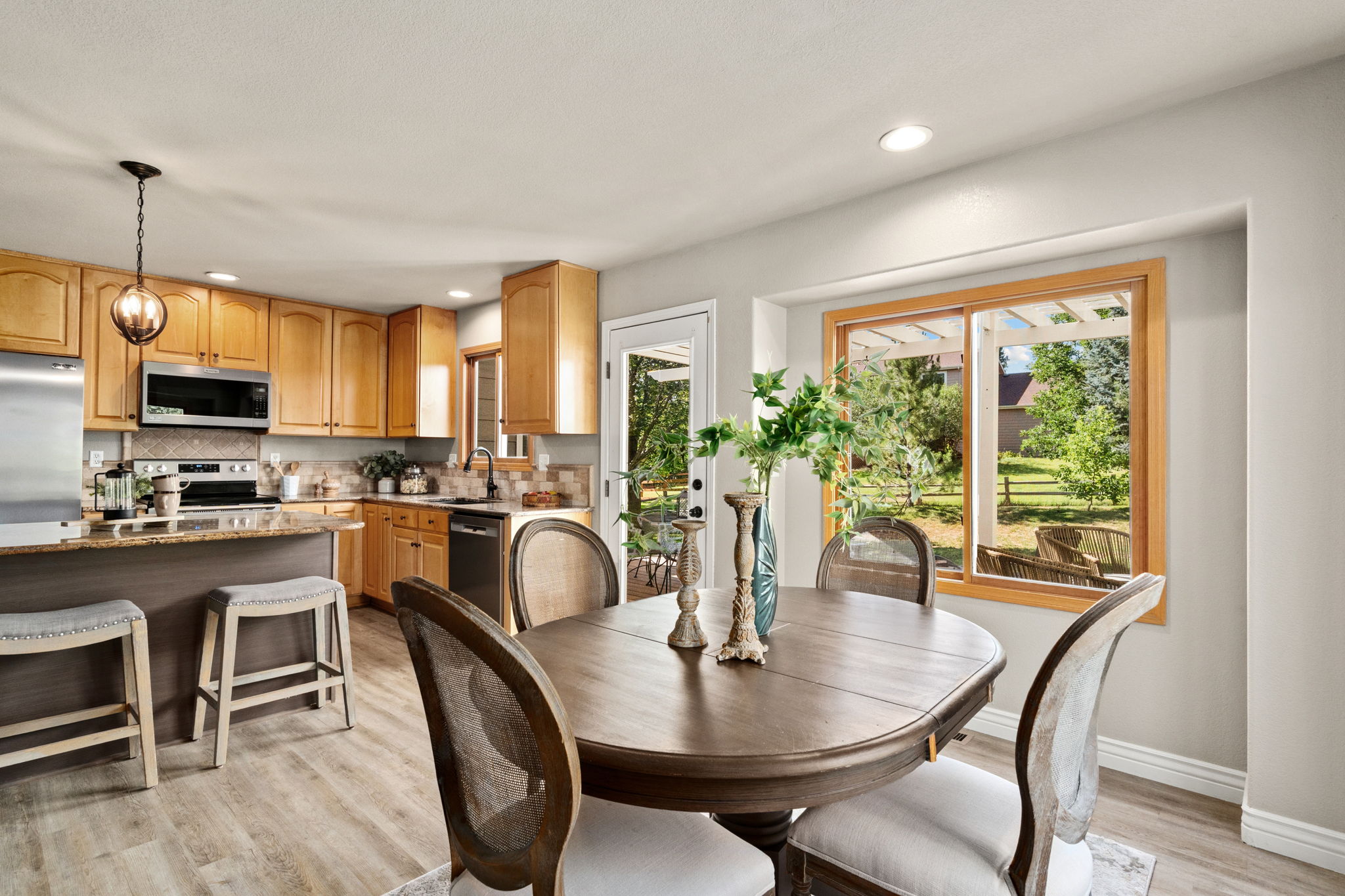 The eat-in kitchen flows well to the amazing outdoor space.