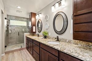 Primary bathroom with double vanity and walk-in shower.