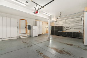 Three car attached garage with backyard access, storage galore, and a garage refrigerator - all included!