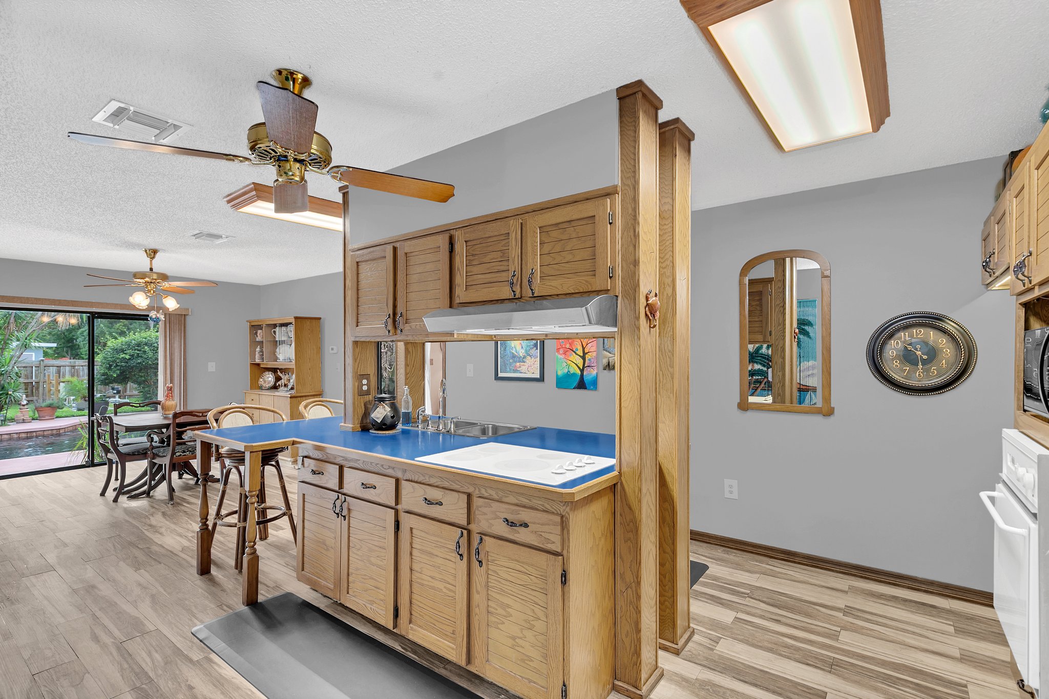 Bright Open Kitchen and dining space. EZ care tile flooring & stellar pool views!