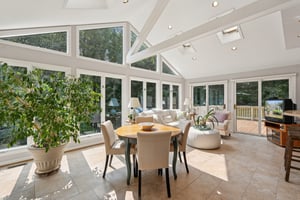 Sun Room featuring Floor to Ceiling Windows and Access to Decks
