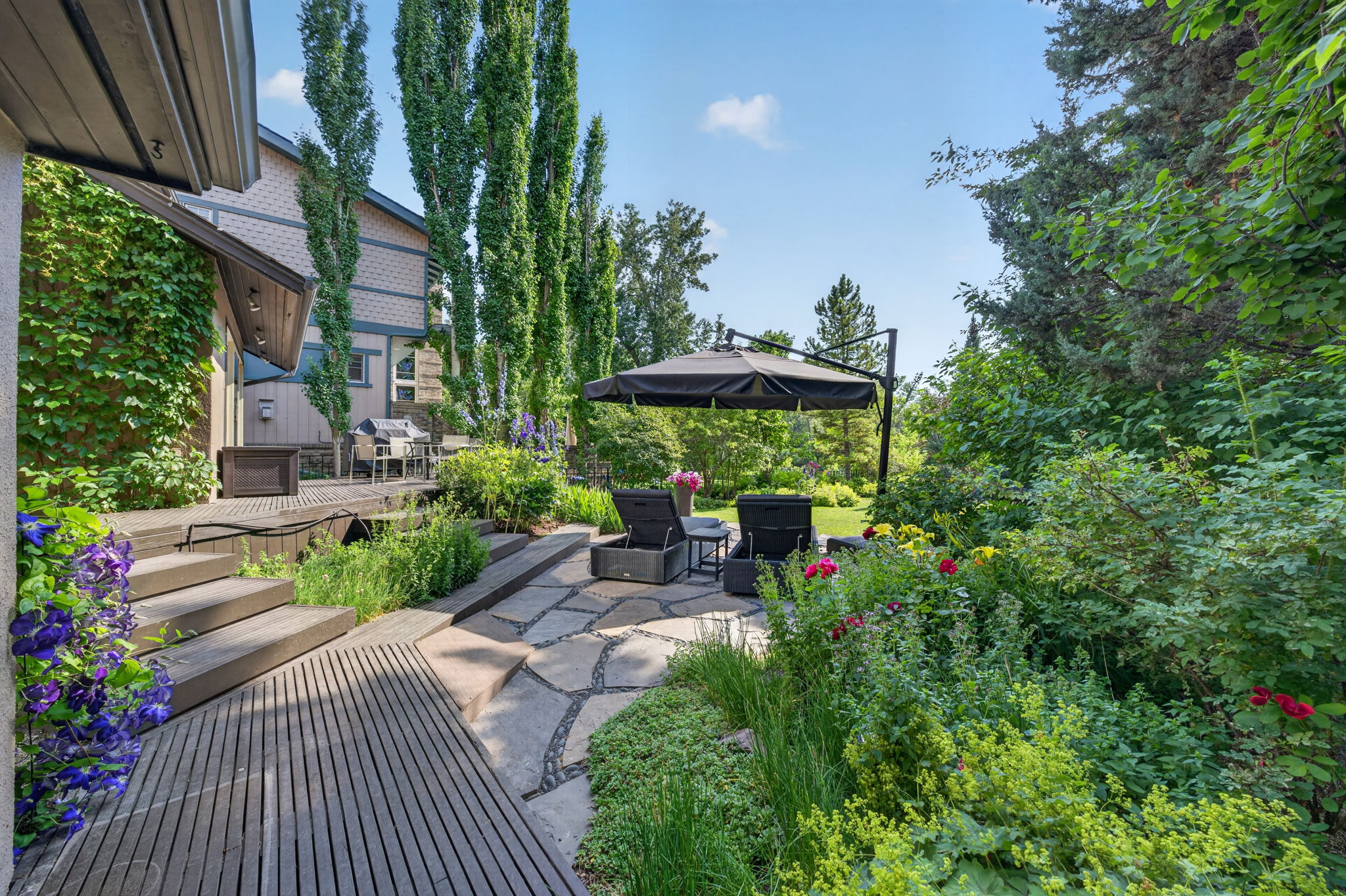 Terraced flagstone patios amid mature gardens