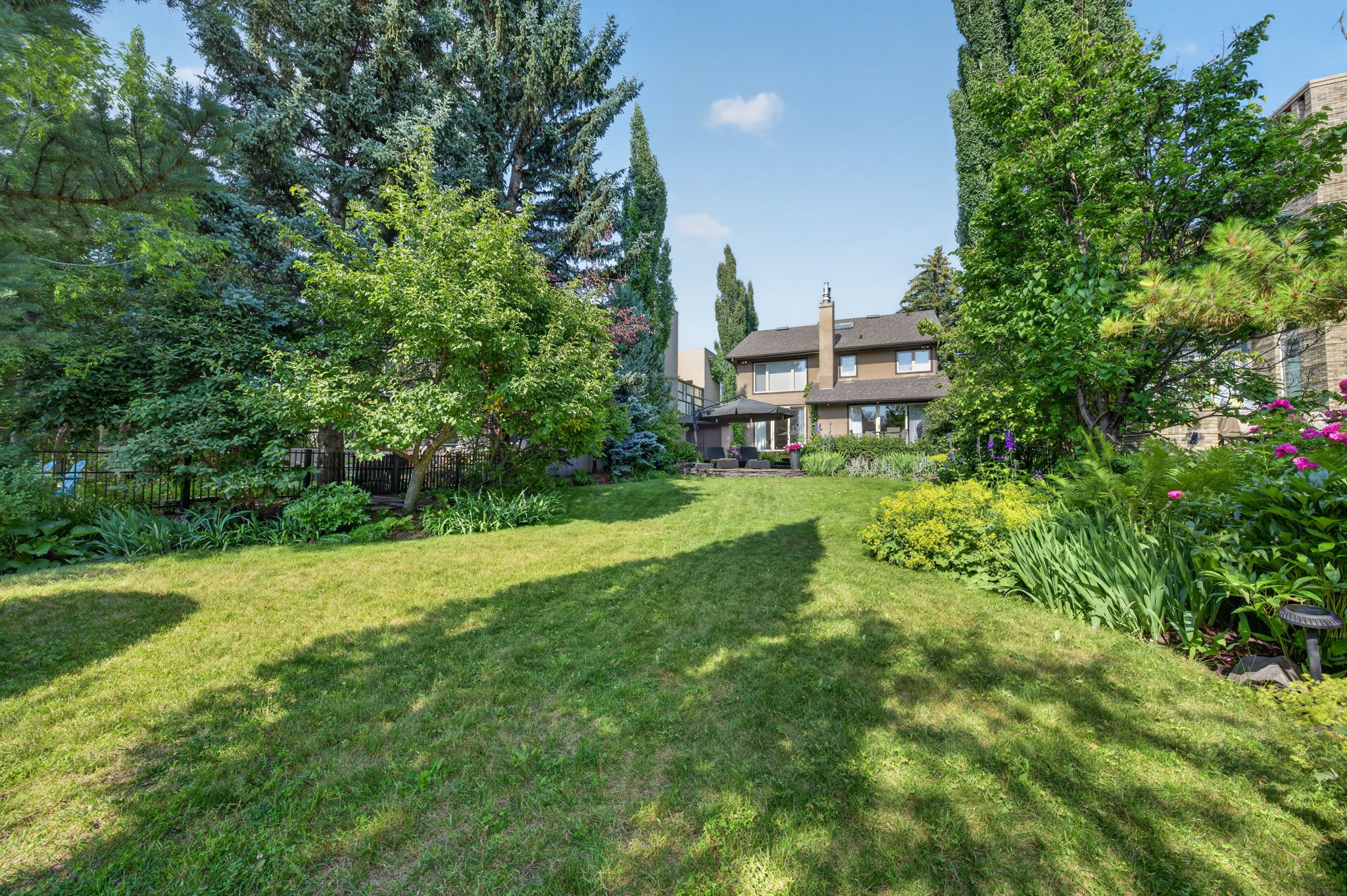 A private, park-like backyard stretching to the river