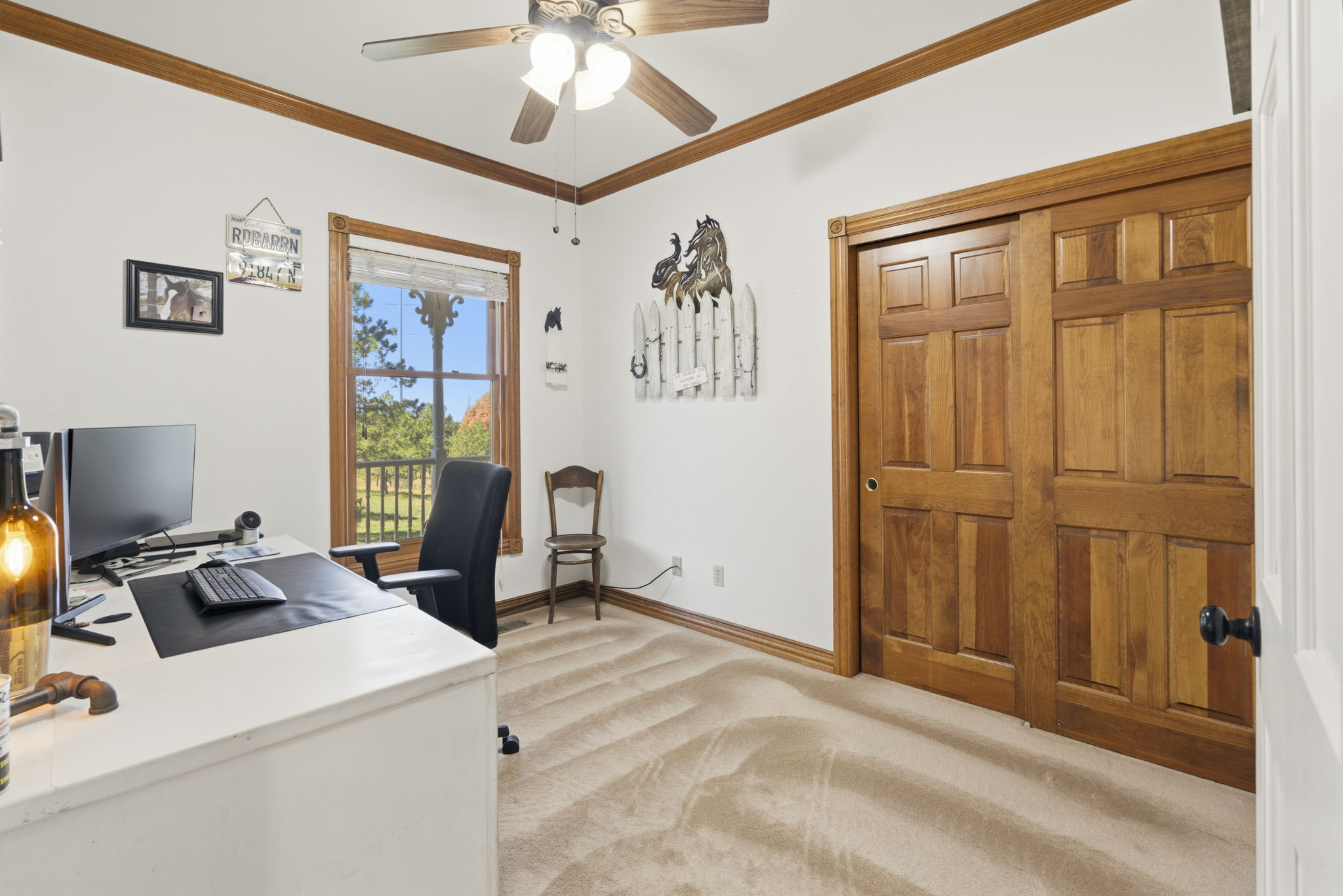 1 of 2 main floor secondary bedrooms currently being used as an office. White desk stays with the home!