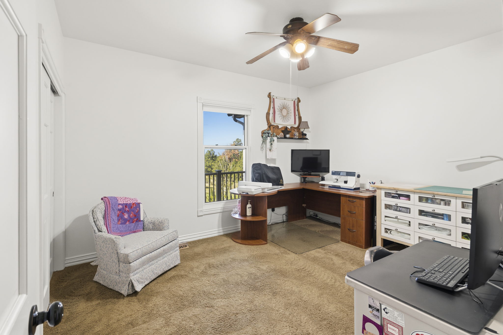 1 of 2 main floor secondary bedrooms currently being used as an office/sewing room.