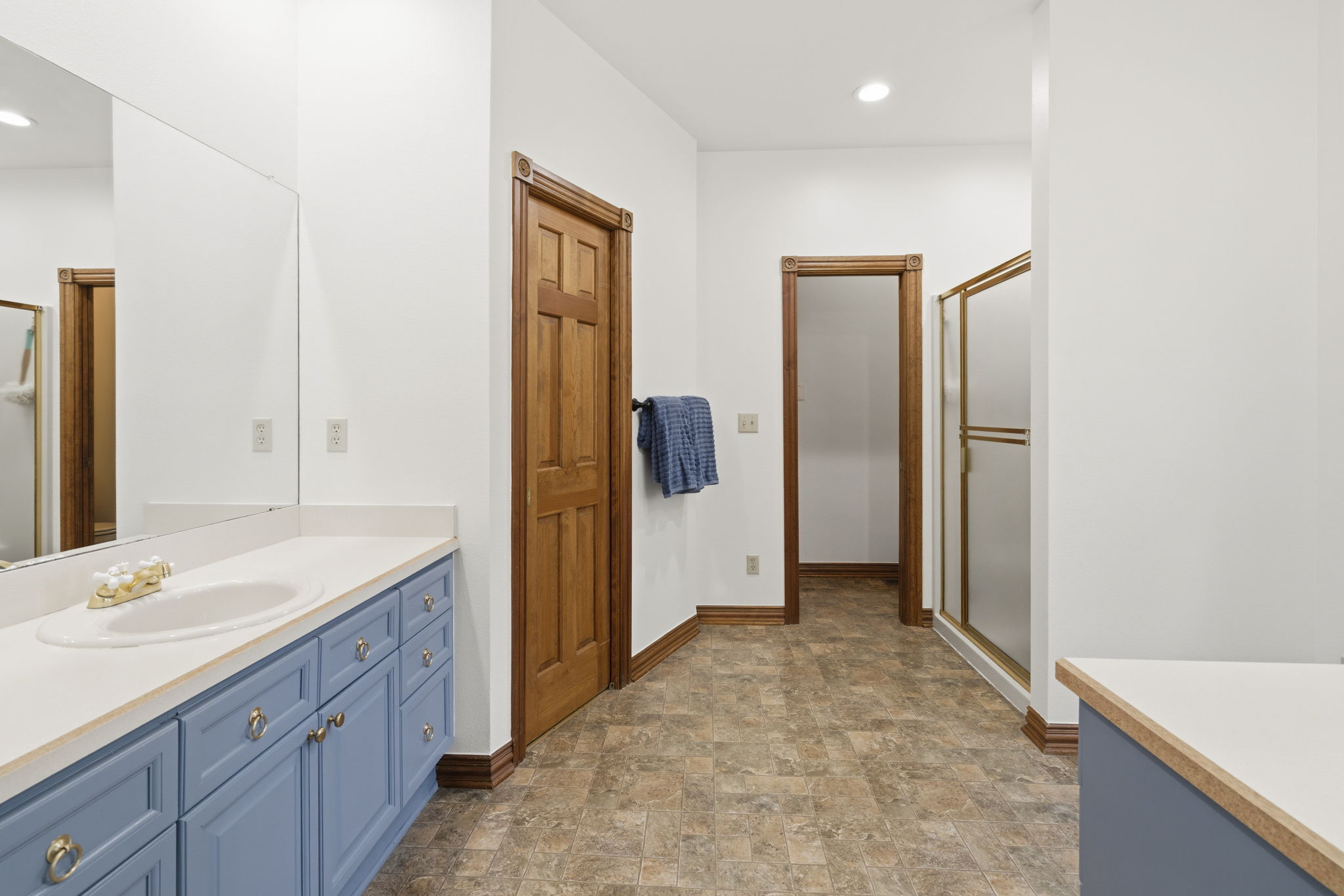 Primary en suite bathroom with large walk in closet.