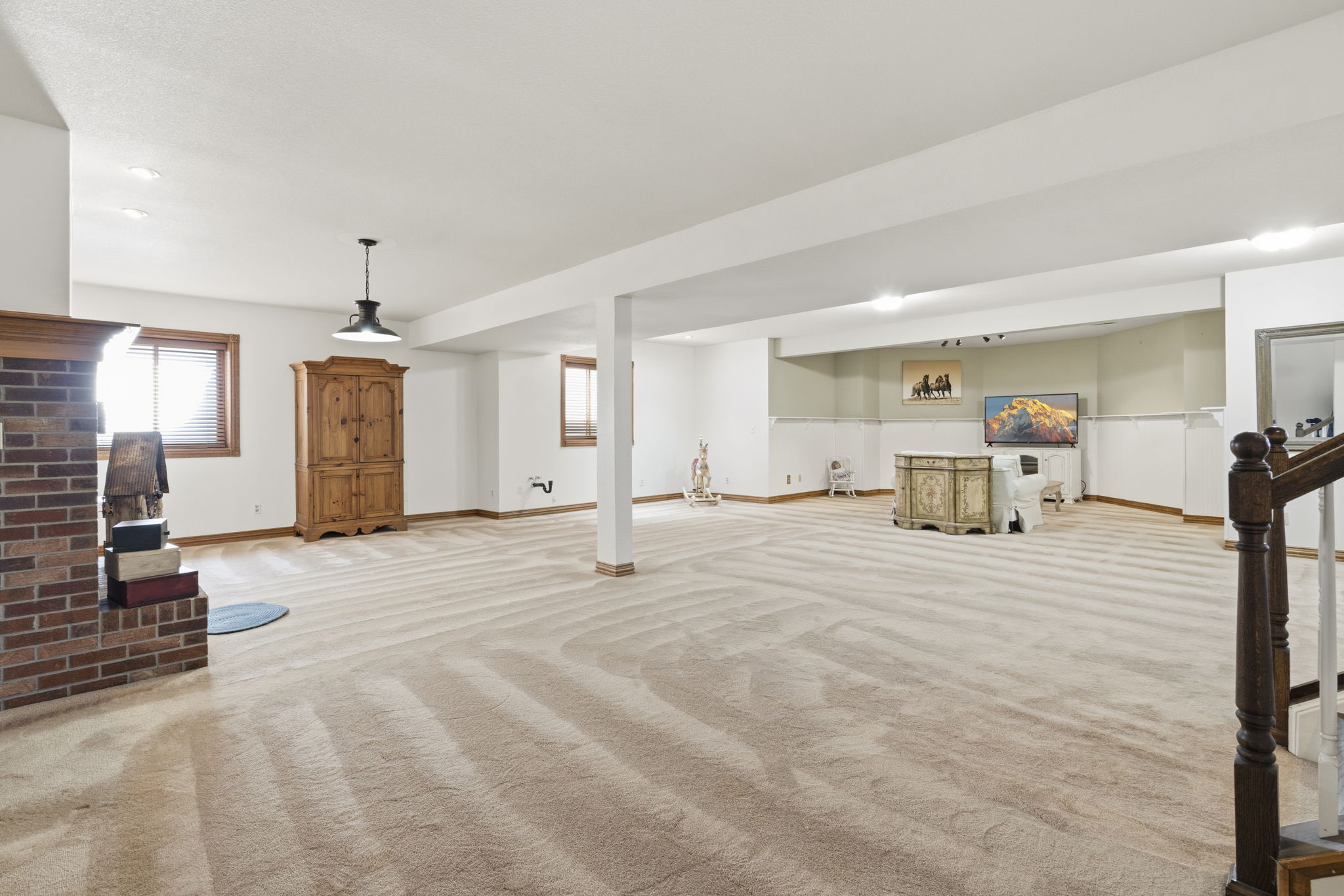 Large lower level main living area with plenty of natural light and space for entertaining.