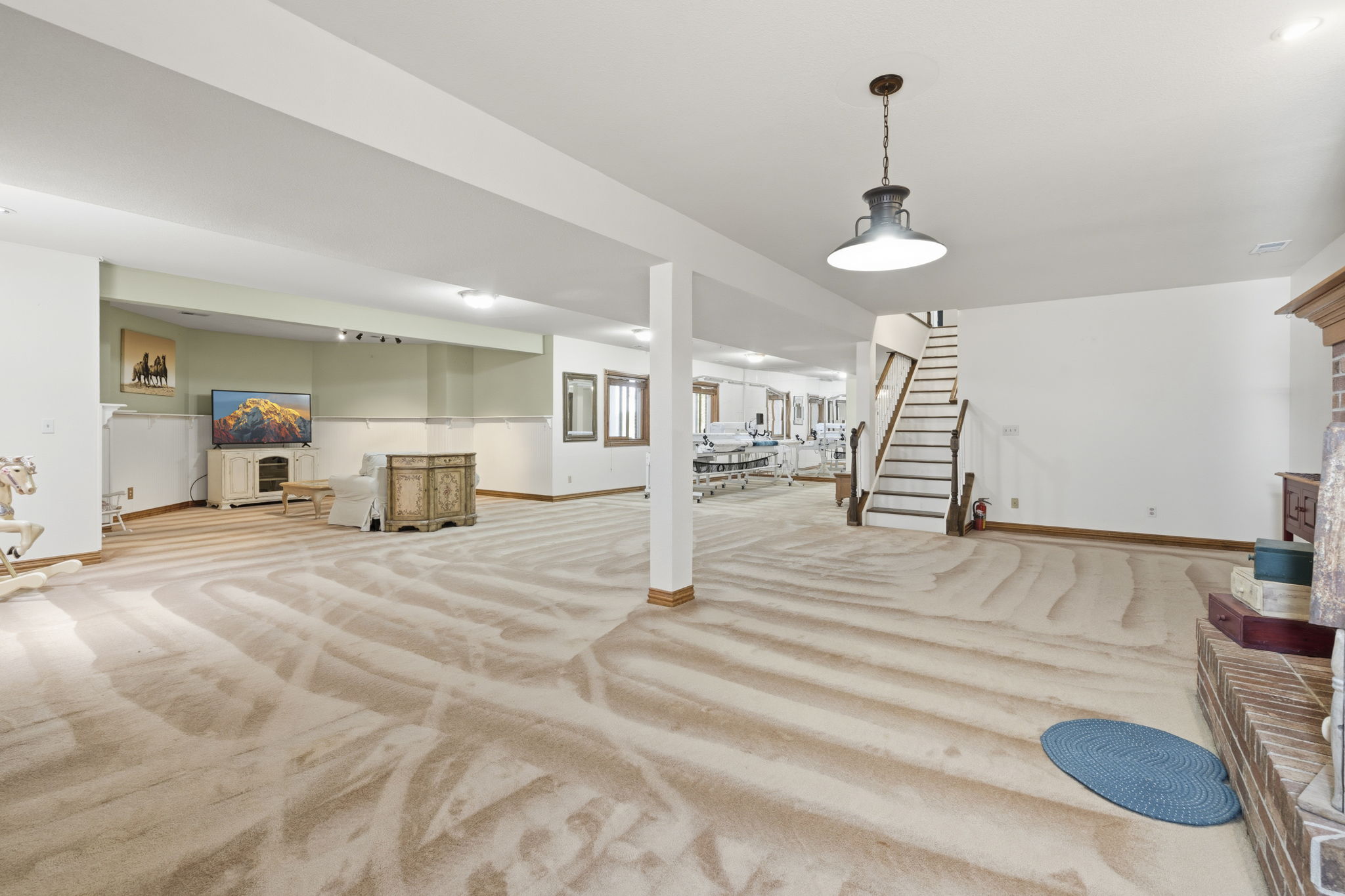 Large lower level main living area with plenty of natural light and space for entertaining.