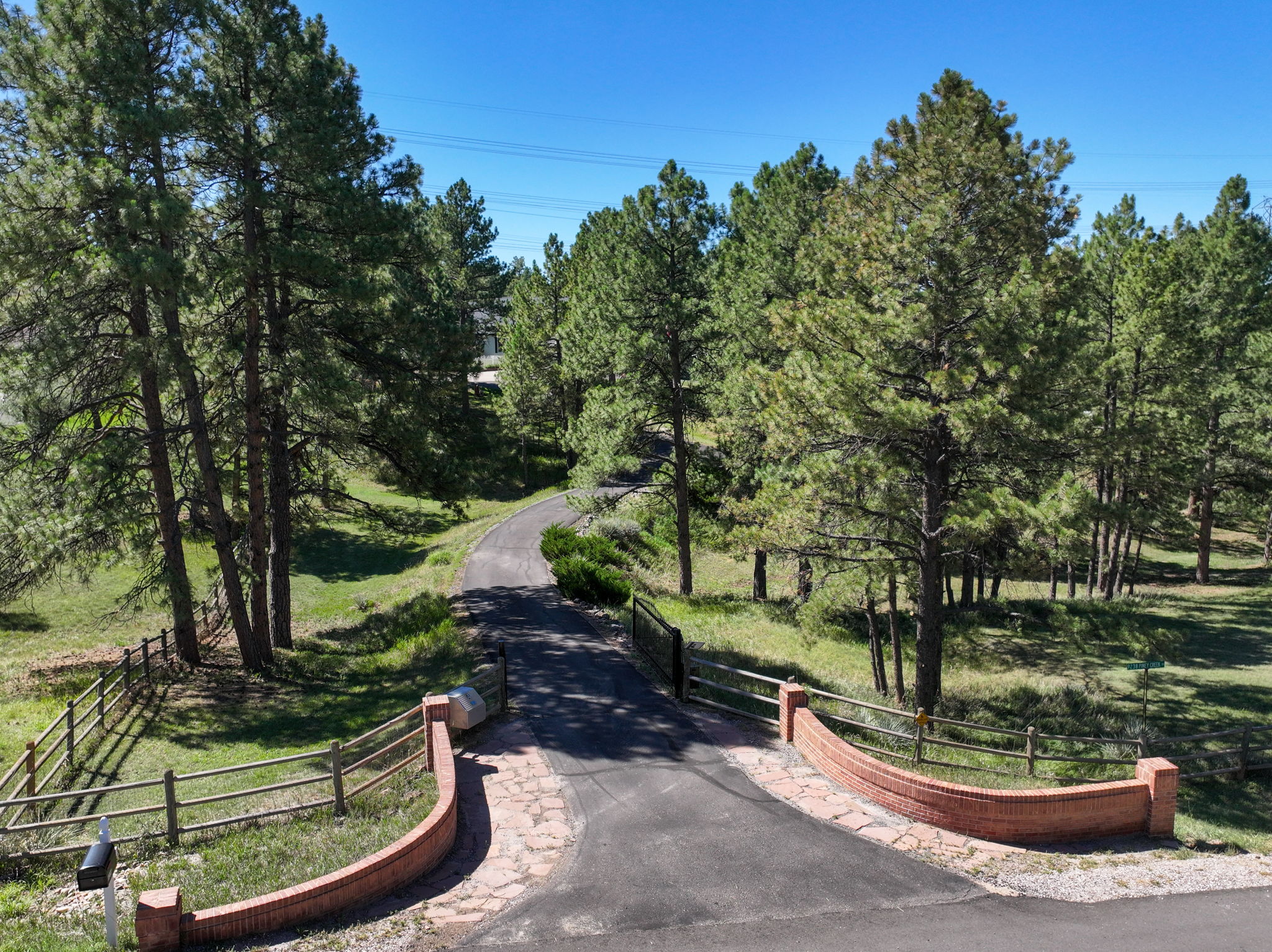 Private gated entry with long driveway to the residence.