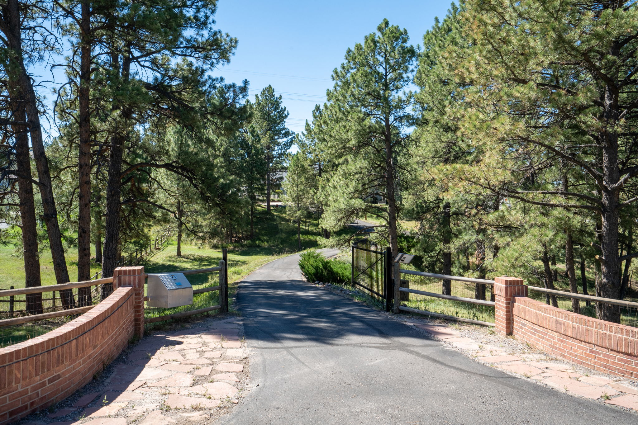 Private gated entry with long driveway to the residence.