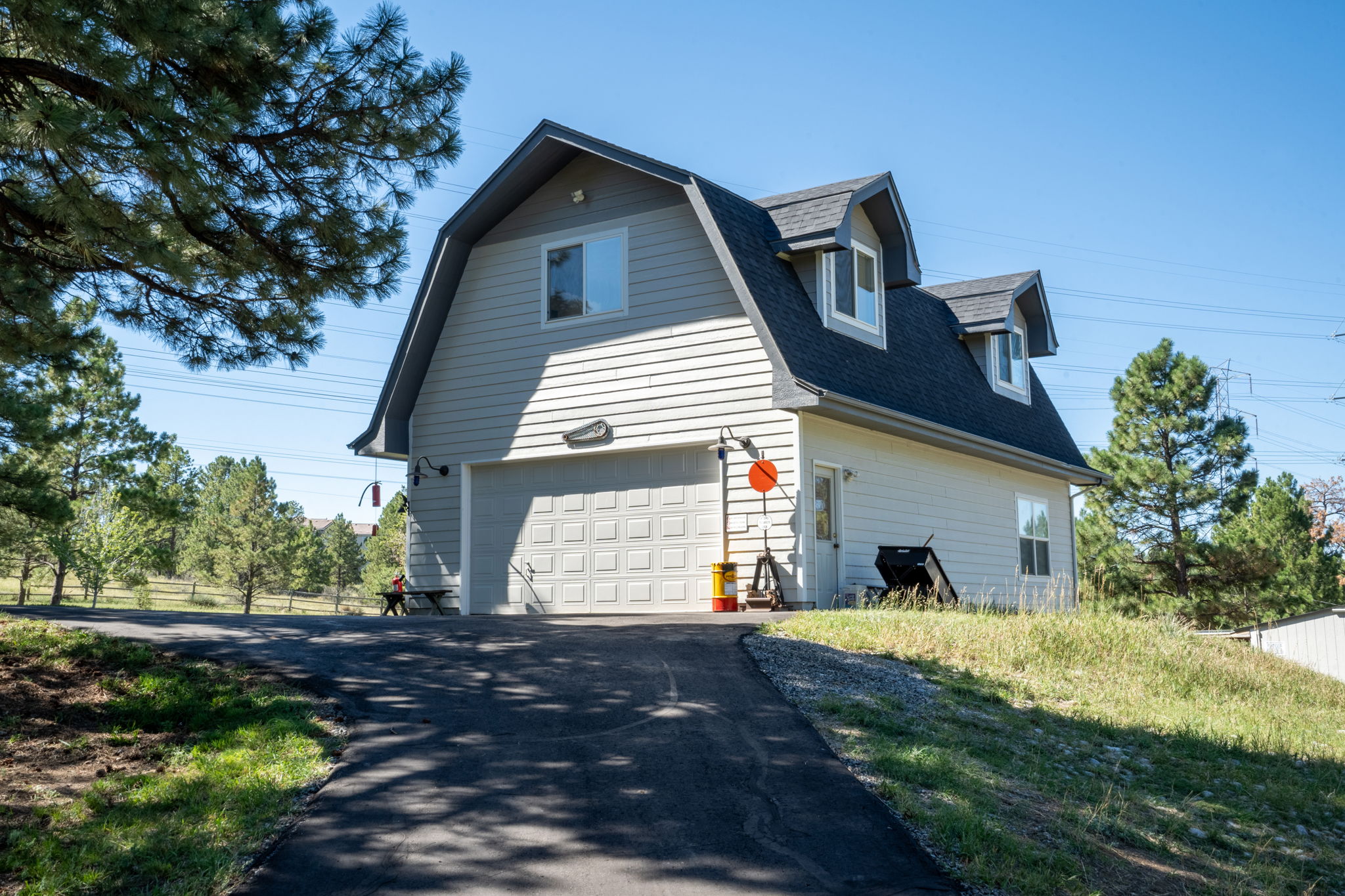 Detached 2 1/2 car garage/workshop with an upper floor private getaway perfect for a game room, home office, home gym or art studio.