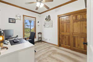 1 of 2 main floor secondary bedrooms currently being used as an office. White desk stays with the home!