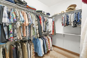 Primary en suite bathroom with large walk in closet.