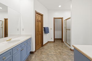 Primary en suite bathroom with large walk in closet.