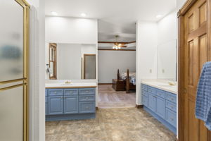 Primary en suite bathroom with large walk in closet.