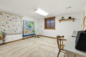 1 of 2 lower level bedrooms currently being used as a sewing room.