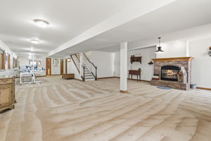 Large lower level main living area with plenty of natural light and space for entertaining.