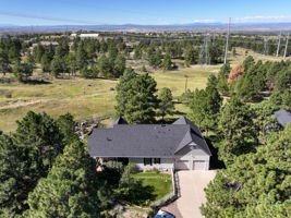 Great view of the back of the home, complete with a 4 car tandem garage and a white picket fenced backyard.