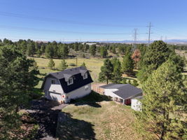 Detached 2 1/2 car garage/workshop with an upper floor private getaway perfect for a game room, home office, home gym or art studio.