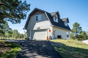 Detached 2 1/2 car garage/workshop with an upper floor private getaway perfect for a game room, home office, home gym or art studio.