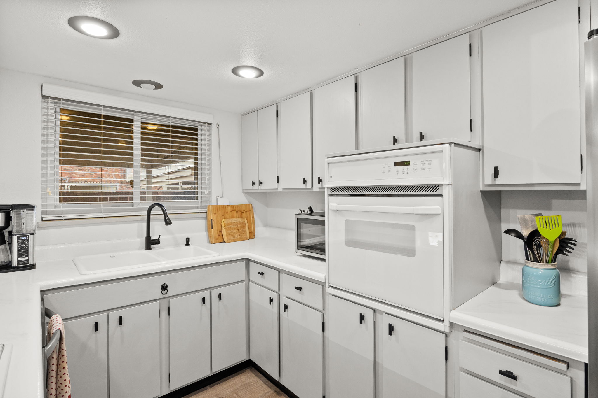 Kitchen window overlooks covered patio