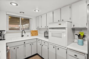 Kitchen window overlooks covered patio