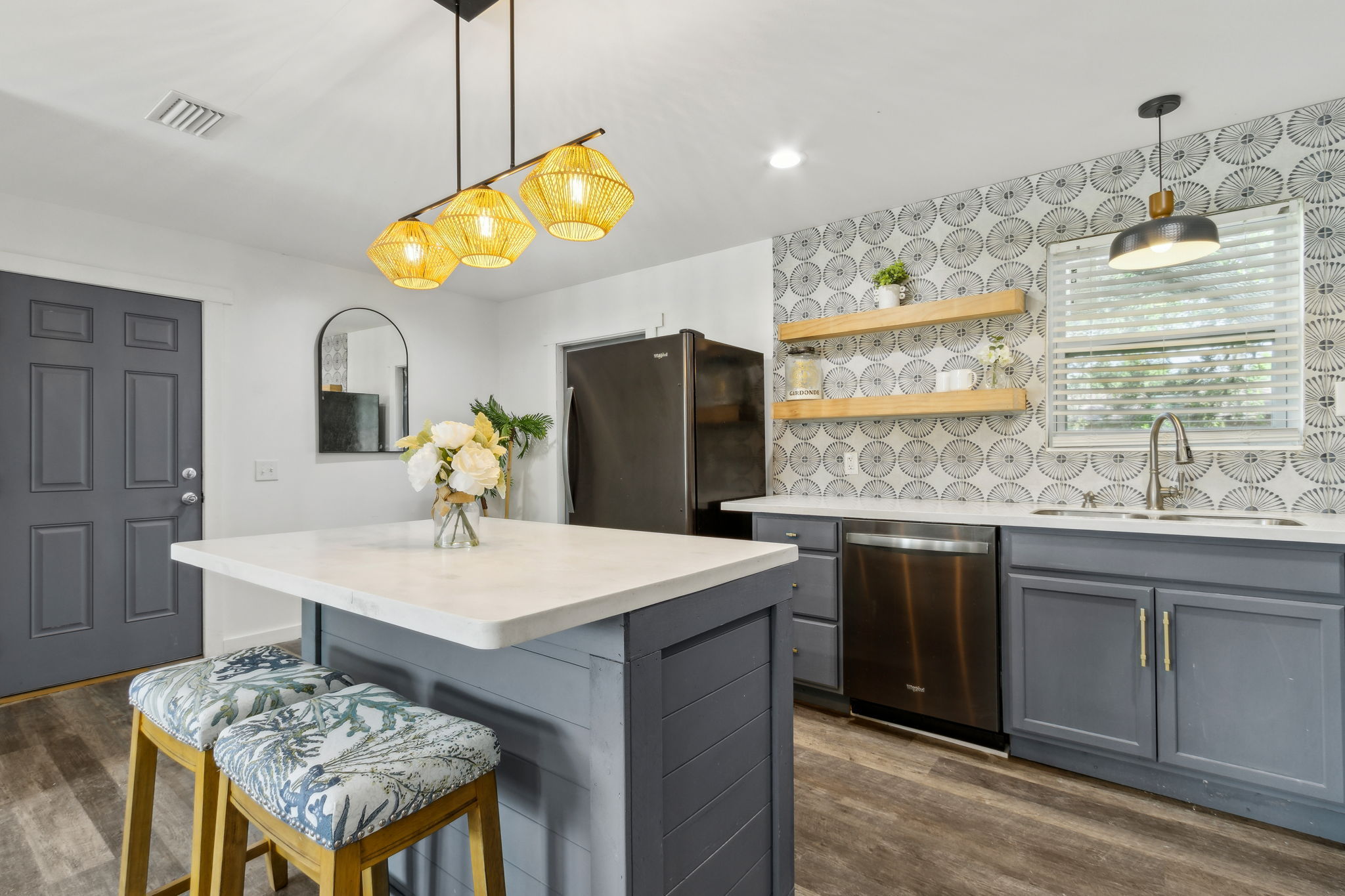 The kitchen is defined by its designer blue-grey cabinetry ...