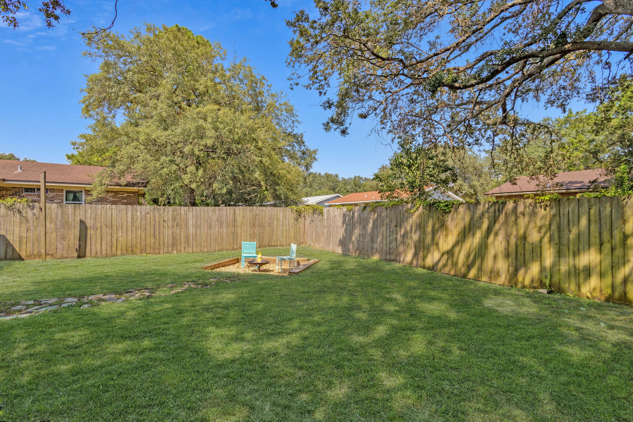 Out back, you'll find a large rear yard, completely fenced, and with plenty of space for outdoor gatherings and activities ...