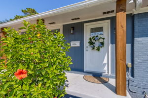 ... with a charming farmers porch and attractive painted brick exterior!