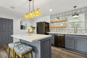 The kitchen is defined by its designer blue-grey cabinetry ...