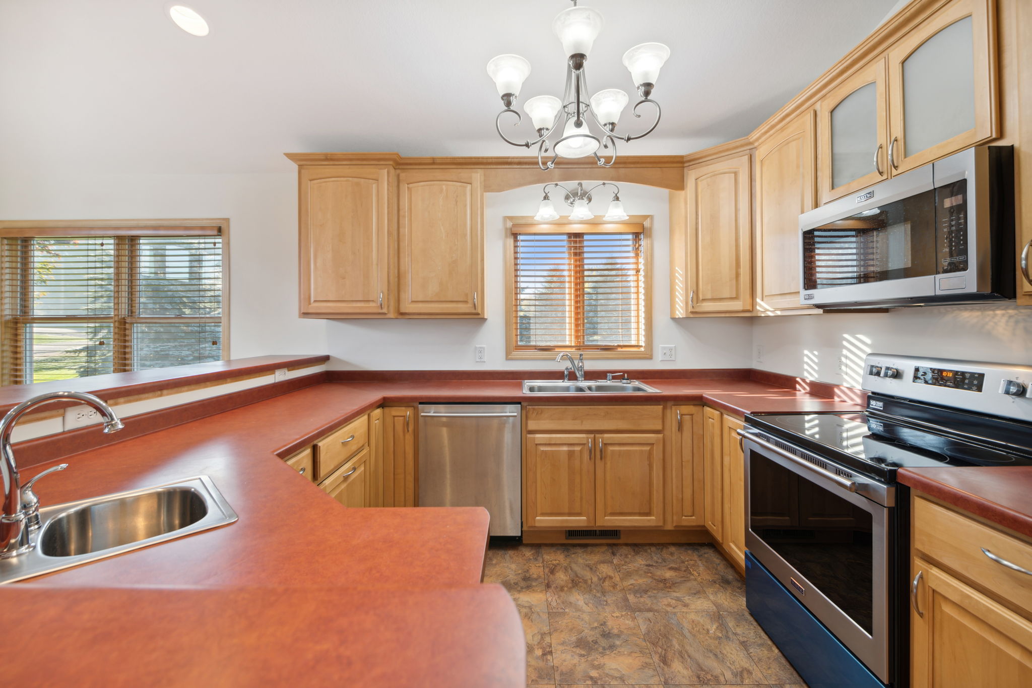 Abundant maple cabinets, large breakfast bar & a new Maytag stainless range & microwave