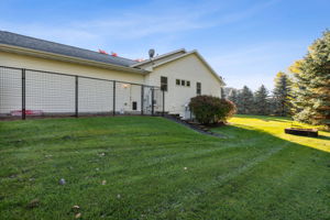 Nicely landscaped with a fenced area just of the garage for your furry friends