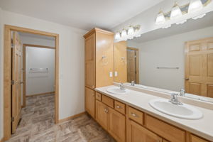Mornings function with ease in the lower bath. A double vanity, lots of cabinets, tub/shower combo & a walk-in additional shower