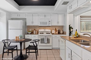 Virtually staged to show the eat-in kitchen possibilities!